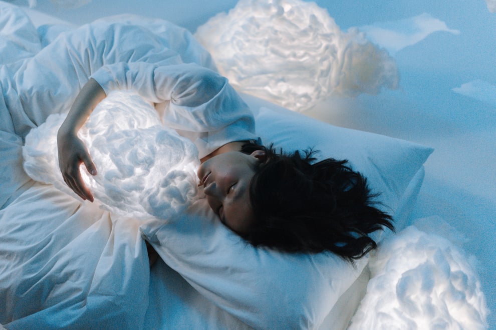 Photo of a Woman Sleeping Hugging a Cloud